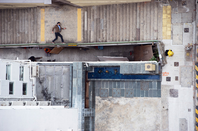 Conceptual Photography by Christian Åslund for Jim Rickey, via Yellowtrace. man walking on balustrade