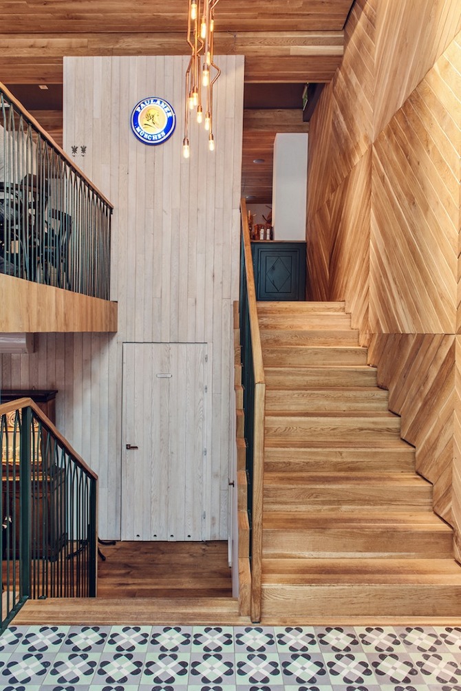 Althaus Restaurant by PB Studio and Filip Kozarski in Gdynia, Poland, via Yellowtrace. Althaus Restaurant, entry, stair, timber wall panelling, copper chandelier