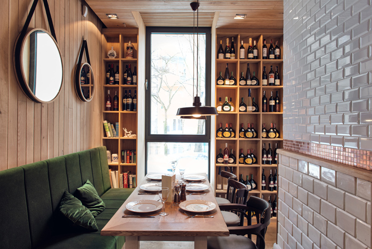 Althaus Restaurant by PB Studio and Filip Kozarski in Gdynia, Poland, via Yellowtrace. Althaus Restaurant, dining room, green velvet upholstery, white wall tiles, wine rack, timber wall panelling